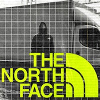 the north face logo with a man standing in front of a truck